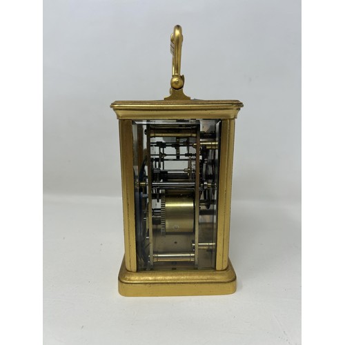 904 - A carriage clock, in a brass and glass case, 18 cm high