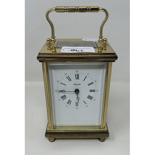 905 - A carriage clock, in a brass and glass case, 56 cm high