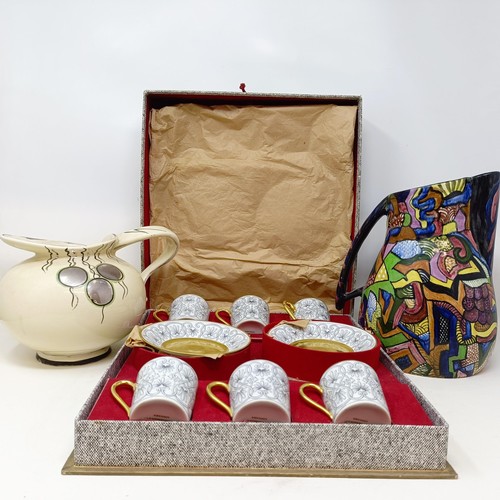 817 - A set of six Limoges coffee cans and saucers, cased, and two jugs (3)