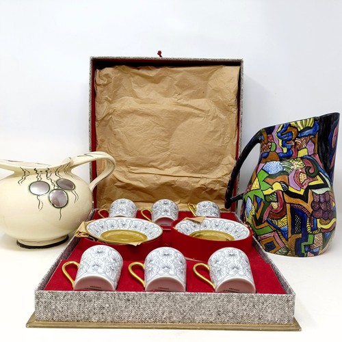 817 - A set of six Limoges coffee cans and saucers, cased, and two jugs (3)