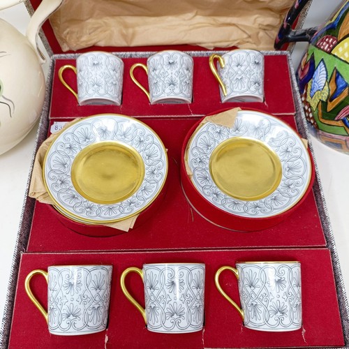 817 - A set of six Limoges coffee cans and saucers, cased, and two jugs (3)