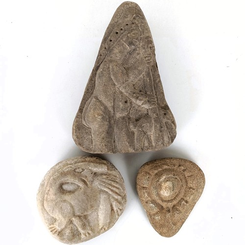 825 - A carved stone, of triangular form, decorated a figure, 22 cm high, and two other stone carvings (3)