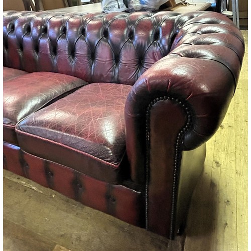 974 - A Chesterfield style red leather sofa, 180 cm wide