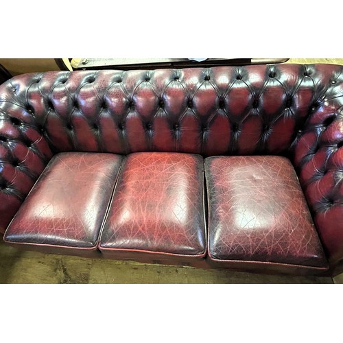 974 - A Chesterfield style red leather sofa, 180 cm wide