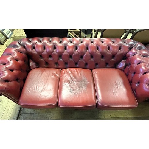 975 - A Chesterfield style red leather sofa, 213 cm wide