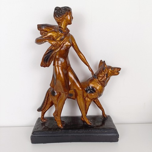 803 - An Art Deco style figure, of a lady with an Alsatian, 35 cm high, an Art Nouveau style brass pin tra... 