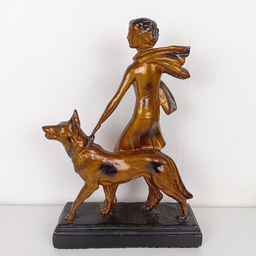 803 - An Art Deco style figure, of a lady with an Alsatian, 35 cm high, an Art Nouveau style brass pin tra... 