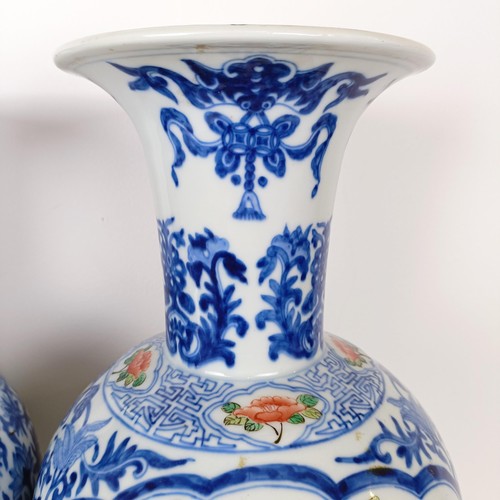 805 - A pair of Chinese blue and white vases, the central cartouche decorated with dragons, 47 cm high (2)