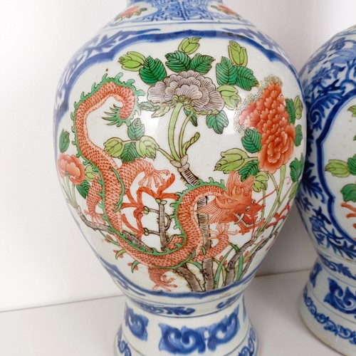 805 - A pair of Chinese blue and white vases, the central cartouche decorated with dragons, 47 cm high (2)