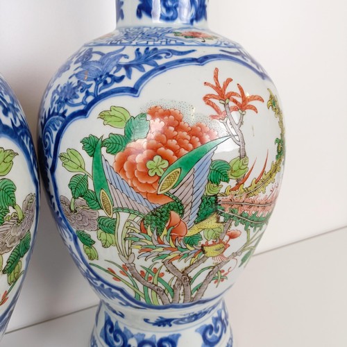 805 - A pair of Chinese blue and white vases, the central cartouche decorated with dragons, 47 cm high (2)