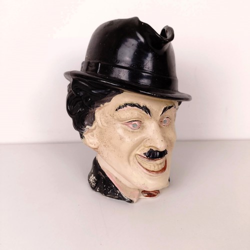 810 - An unusual character jug, in the form of Charlie Chaplin, 23 cm high, handle repaired