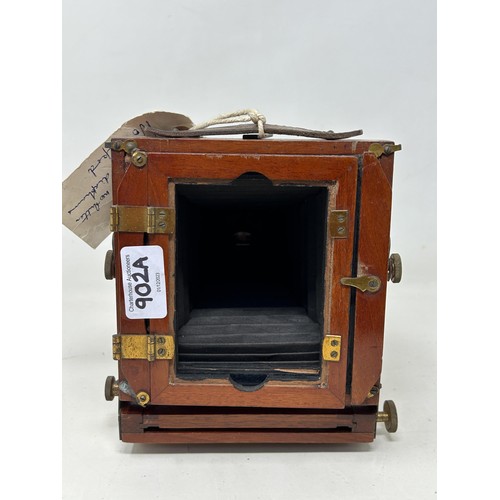 902A - A late 19th/early 20th century mahogany cased plate camera, with plates