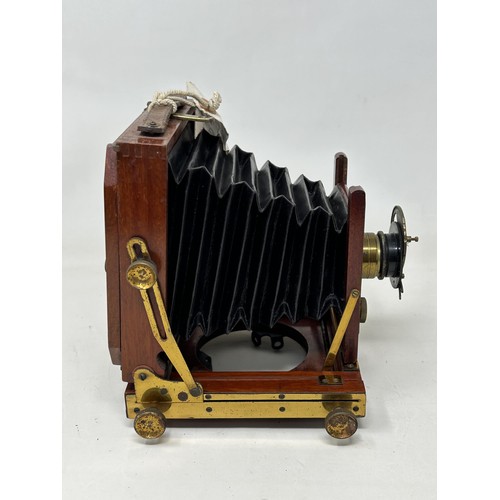 902A - A late 19th/early 20th century mahogany cased plate camera, with plates