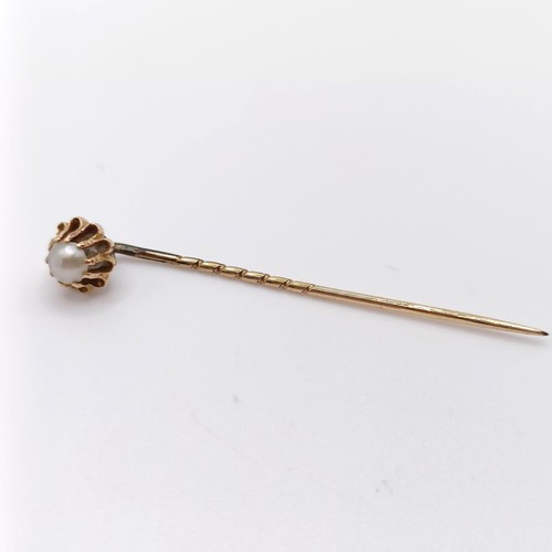 233 - A late 19th/early 20th century yellow metal and seed pearl stick pin