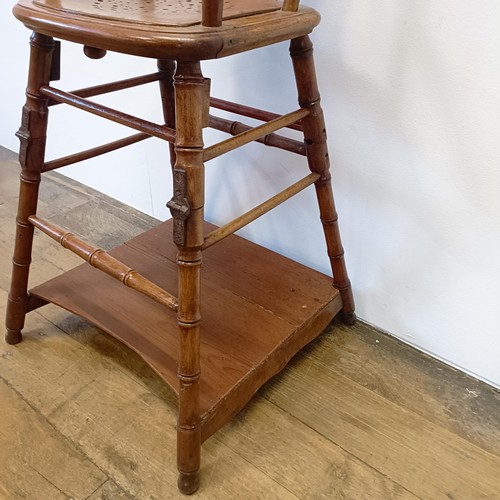 785 - A childs metamorphic highchair, with faux bamboo supports, 100 cm high