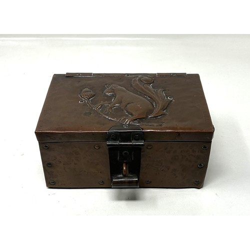 386 - A John Pearson copper box, decorated a squirrel and acorns, monogrammed J P, 17 cm wide