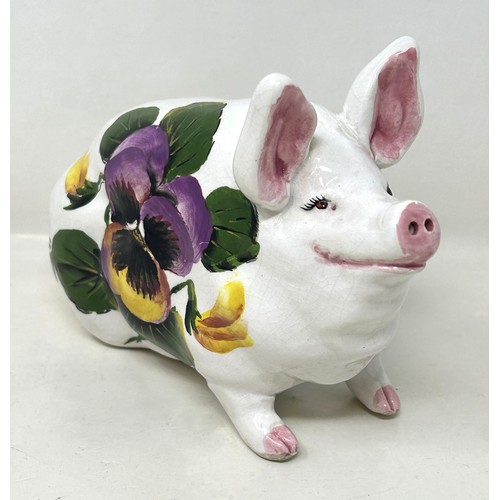 388 - An Exon Wemyss pottery pig, decorated flowers, signed B Adams and dated '87, 18 cm wide