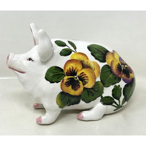 388 - An Exon Wemyss pottery pig, decorated flowers, signed B Adams and dated '87, 18 cm wide