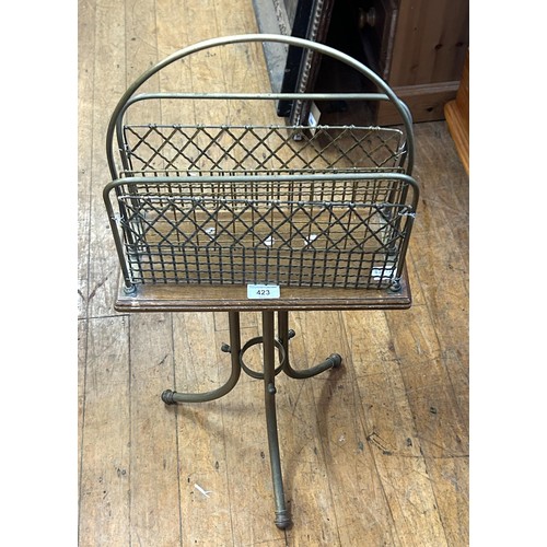 423 - An early 20th century brass and oak magazine rack, 80 cm high