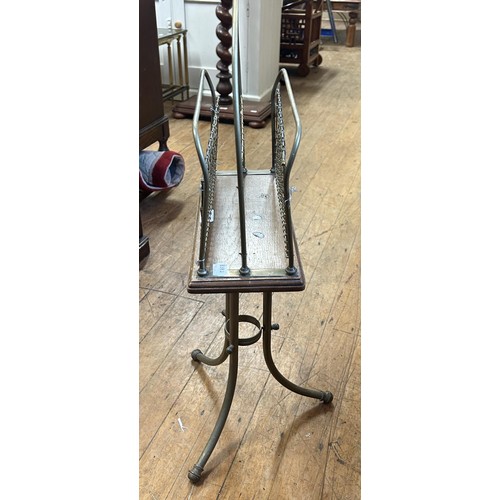 423 - An early 20th century brass and oak magazine rack, 80 cm high