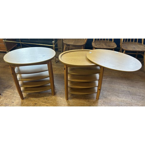 427 - A pair of 20th century teak oval side tables, with revolving tops, 62 cm wide (2)