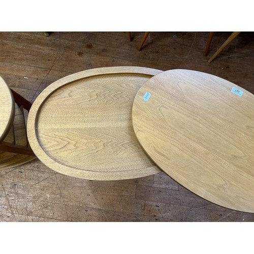 427 - A pair of 20th century teak oval side tables, with revolving tops, 62 cm wide (2)