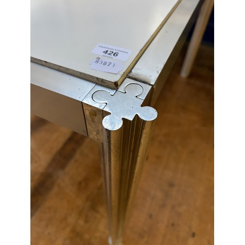 426 - An Italian Ciancimino stainless steel and laminate three section table