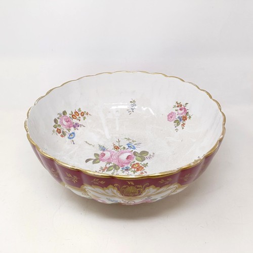 503 - A Continental porcelain bowl, with a red ground, decorated flowers, highlighted in gilt, 34 cm diame... 