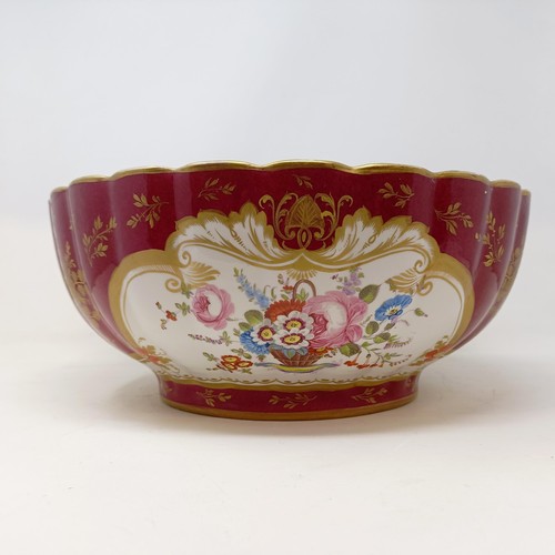 503 - A Continental porcelain bowl, with a red ground, decorated flowers, highlighted in gilt, 34 cm diame... 