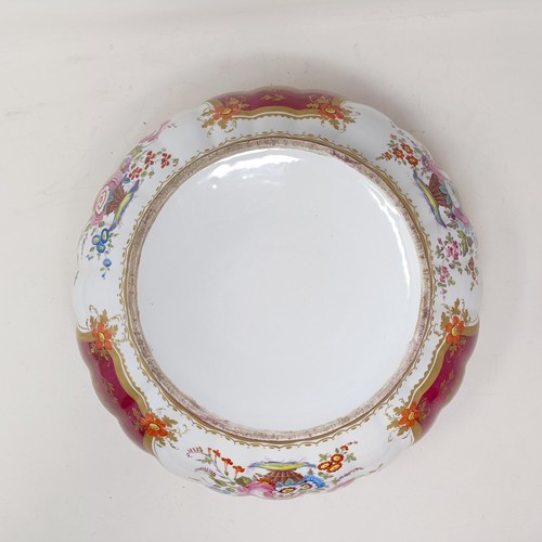 503 - A Continental porcelain bowl, with a red ground, decorated flowers, highlighted in gilt, 34 cm diame... 