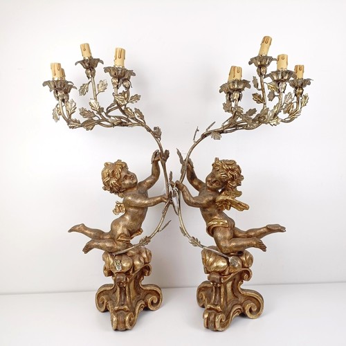 506 - A pair of giltwood and metal lamps, in the form of cherubs, 80 cm high (2)