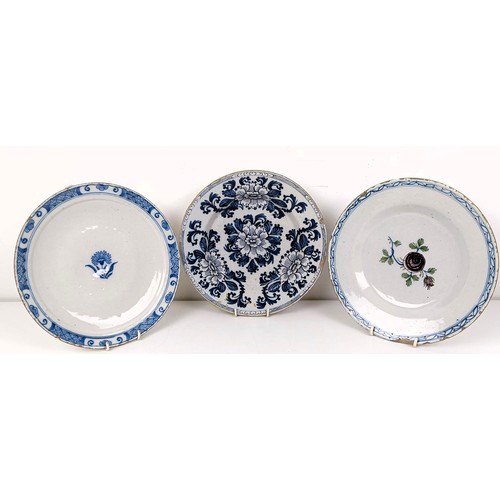 510 - A blue and white Delft plate, decorated flowers, 23 cm diameter, and two others (3)