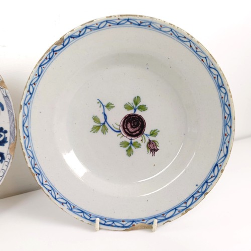 510 - A blue and white Delft plate, decorated flowers, 23 cm diameter, and two others (3)