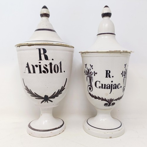 514 - A near pair of 19th century Delft apothecary jars and covers, reading R Aristol, and R G Uagac, 30 c... 