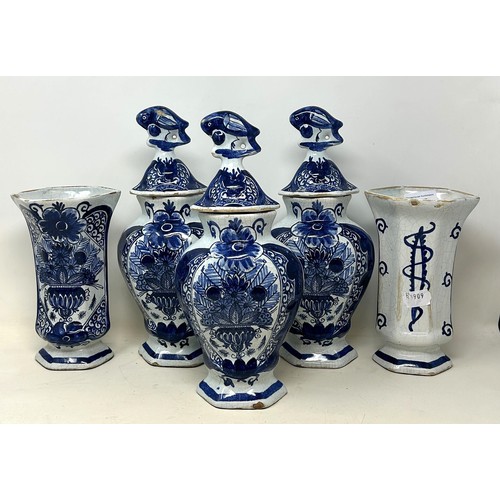 517 - A Delft garniture, comprising three vases and covers, 34 cm high, and a pair of vases, 20 cm high (5... 