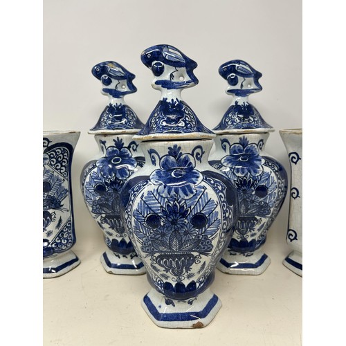 517 - A Delft garniture, comprising three vases and covers, 34 cm high, and a pair of vases, 20 cm high (5... 