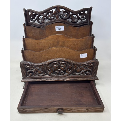 520 - A Continental carved and pierced letter rack, decorated floral forms, 33 cm wide