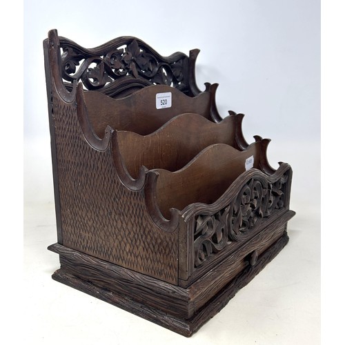 520 - A Continental carved and pierced letter rack, decorated floral forms, 33 cm wide