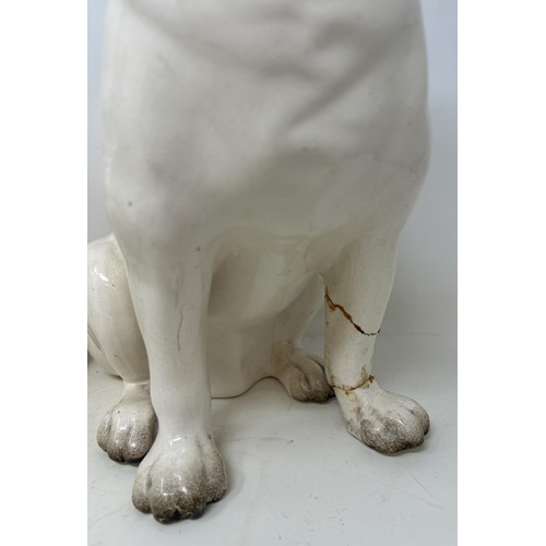 521 - A pair of pottery pugs, 28 cm high (2)