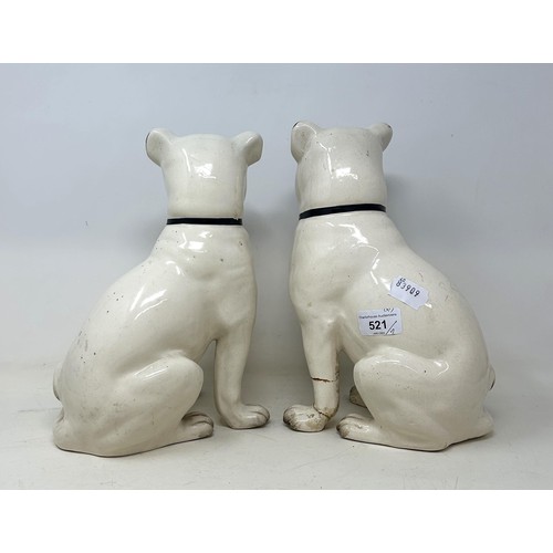 521 - A pair of pottery pugs, 28 cm high (2)