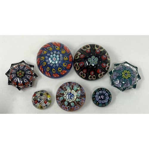 606 - A Vasart glass paperweight, a Strathern glass paperweight, and five others (7)