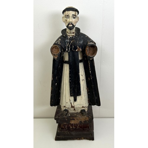 536 - A carved and painted figure of a saint, lacking arms, on a rectangular base, 60 cm high