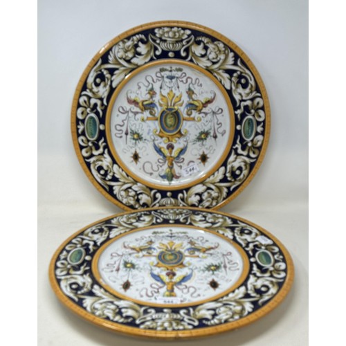 544 - A pair of majolica pottery chargers, decorated floral forms, 43 cm diameter (2)