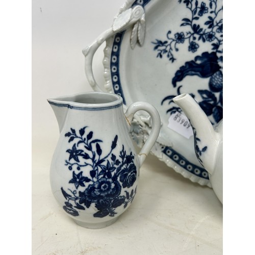 546 - An 18th century Worcester blue and white teapot, 13 cm high, two cream jugs, a twin handled tray, an... 