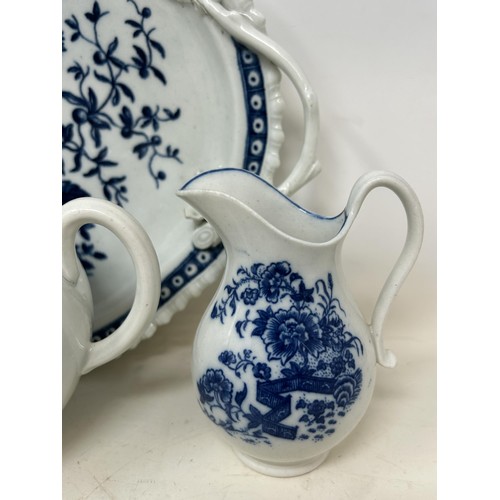 546 - An 18th century Worcester blue and white teapot, 13 cm high, two cream jugs, a twin handled tray, an... 