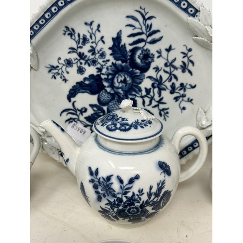 546 - An 18th century Worcester blue and white teapot, 13 cm high, two cream jugs, a twin handled tray, an... 