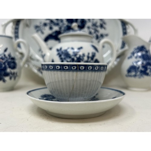 546 - An 18th century Worcester blue and white teapot, 13 cm high, two cream jugs, a twin handled tray, an... 