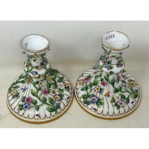 549 - A pair of porcelain candlesticks, decorated flowers, 117 cm high, and a part dessert service