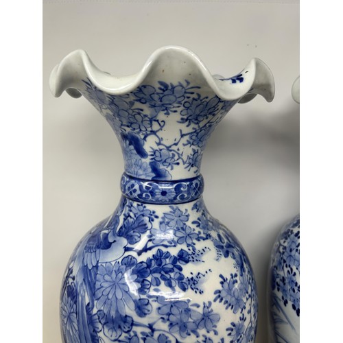 524 - **Regretfully withdrawn**A pair of Japanese blue and white vases, decorated birds and flowers, 46 cm... 