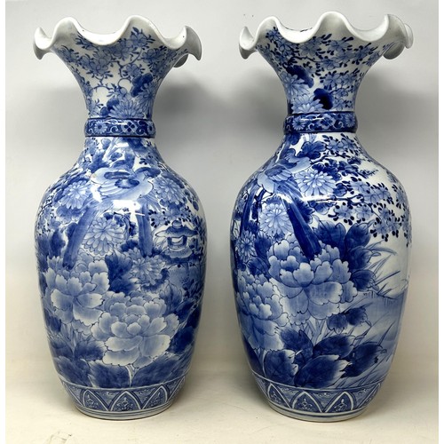 524 - **Regretfully withdrawn**A pair of Japanese blue and white vases, decorated birds and flowers, 46 cm... 